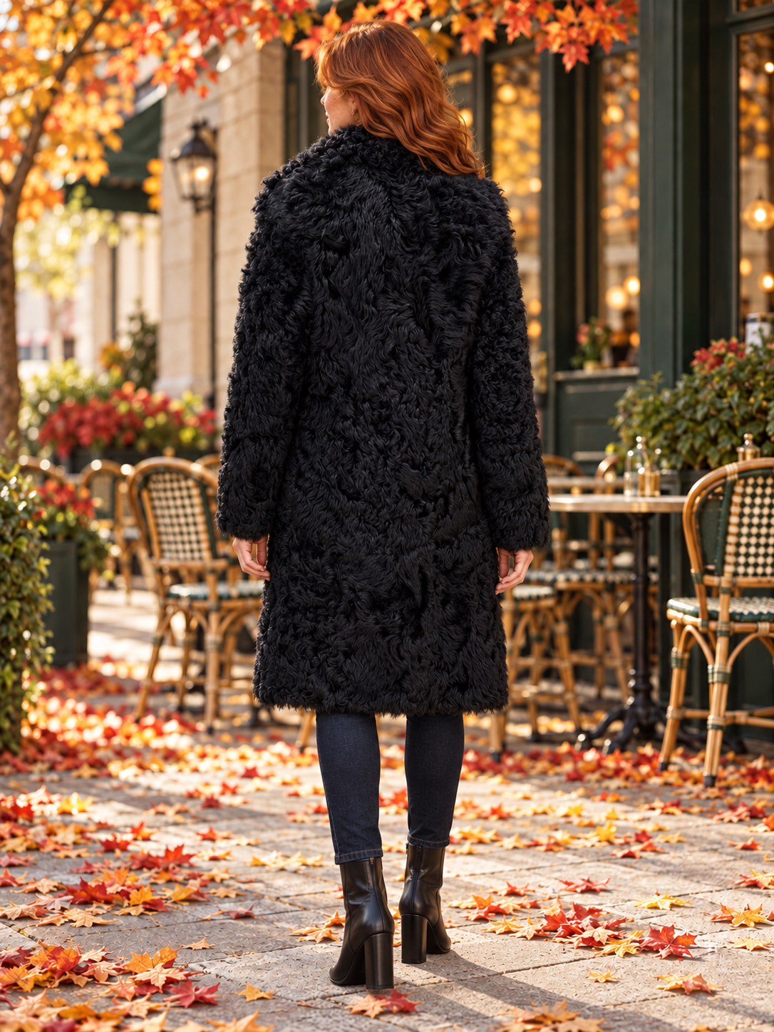 Dyed Black Shearling Reversible Coat — fur side, back view on redheaded model outside autumn cafe